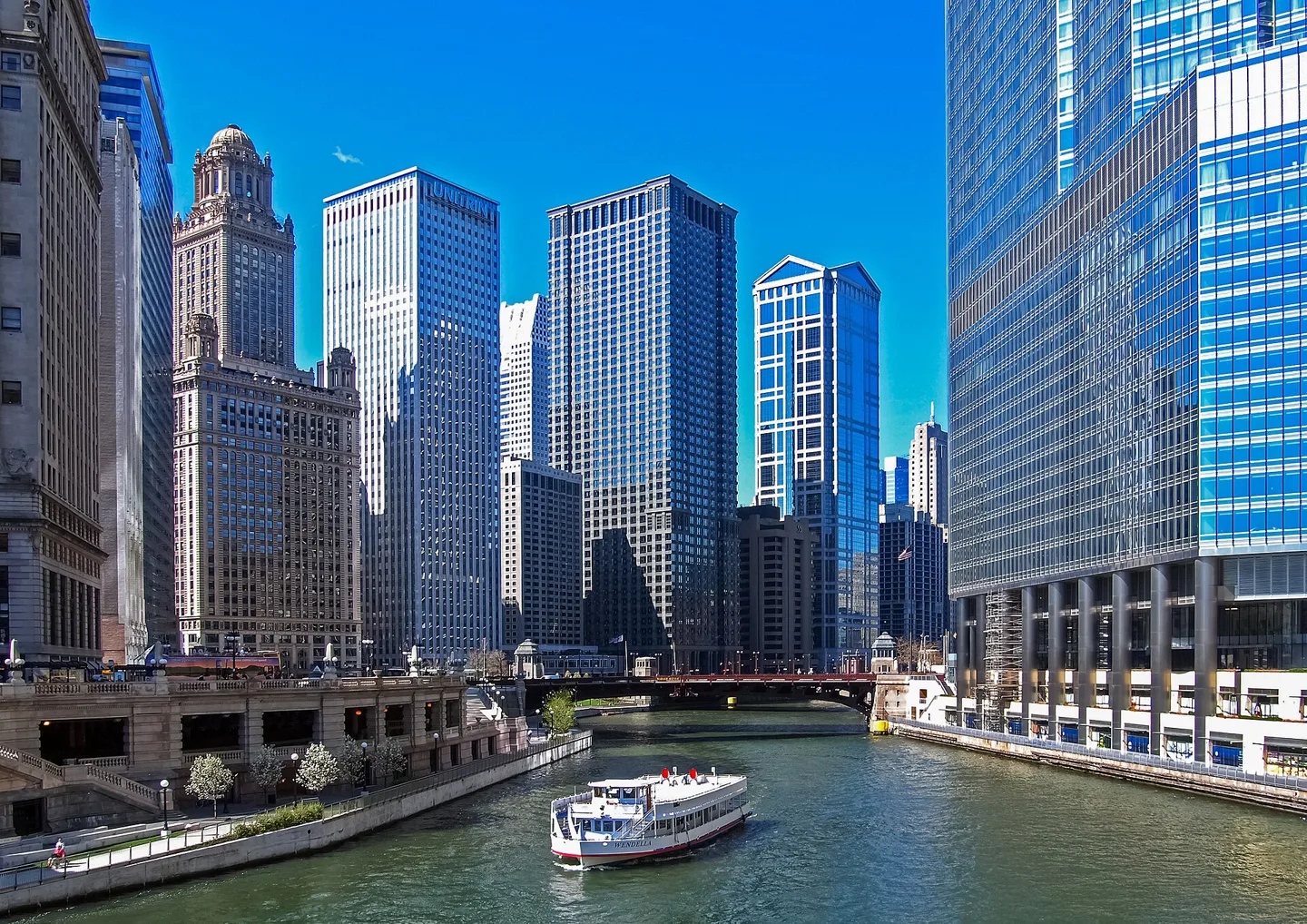 Chicago River and downtown towers with a boat on the water